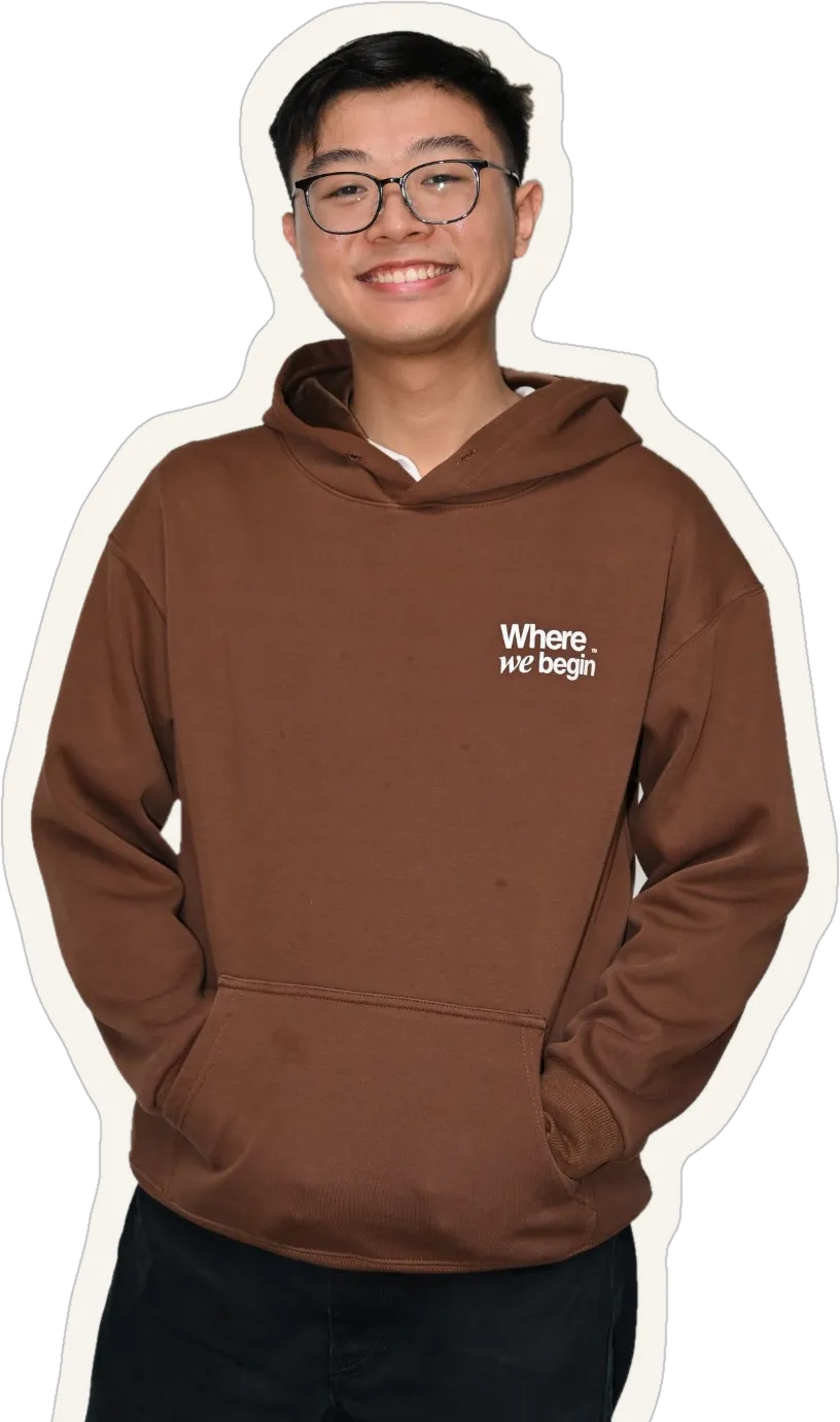 Benedict Kok smiling, in glasses and a brown WhereWeBegin hoodie, cut out like a sticker.